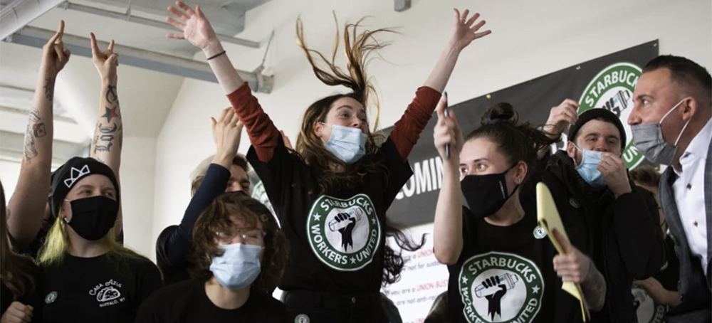 Starbucks employees and supporters react to a successful unionization vote on Thursday in Buffalo, N.Y., pointing the way to a new labor model for the coffee giant. (photo: Joshua Bessex/AP)