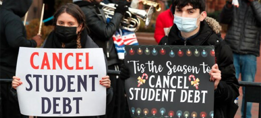 Activists hold signs calling on President Biden to cancel student debt while musicians perform outside the White House grounds on Dec. 15. (photo: Paul Morigi/Getty Images/The 45 Million)