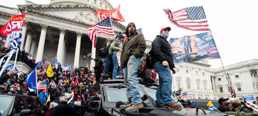 Trump supporters stand on the U.S. Capitol Police armored vehicle as others take over the steps of the Capitol on Wednesday, Jan. 6, 2021. (photo: Bill Clark/Getty)