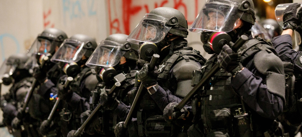 Riot police confront demonstrators gathered over the death of George Floyd an unarmed black man who died after being pinned down by a white police officer, on May 31, 2020, in Portland, Oregon. (photo: John Rudoff/Anadolu Agency/Getty Images)