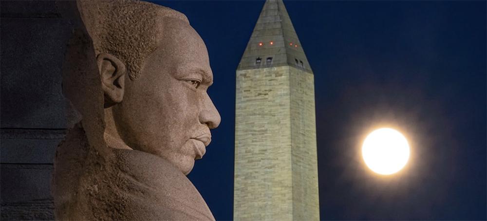The rising full moon passes behind the Martin Luther King Jr. Memorial and the Washington Monument in December 2020 in D.C. (photo: J. David Ake/AP)