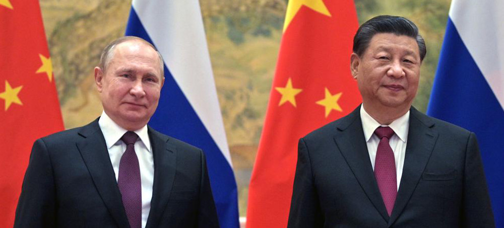 Chinese president Xi Jinping, right, and Russian president Vladimir Putin pose for a photo prior to their talks in Beijing, China, Friday, Feb. 4, 2022. (photo: Alexei Druzhinin/AP)