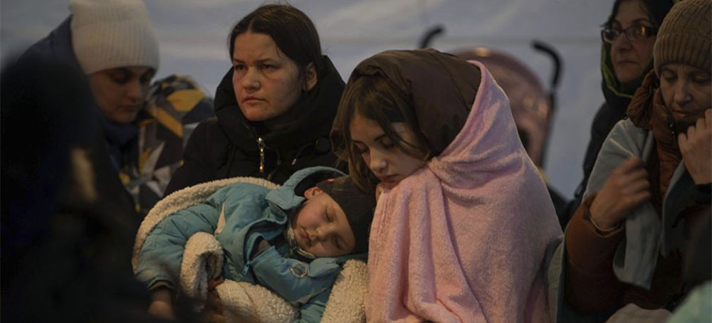 Refugees, mostly women with children, rest inside a tent after arriving at the border crossing, in Medyka, Poland on Sunday, March 6, 2022. (photo: Visar Kryeziu/AP)