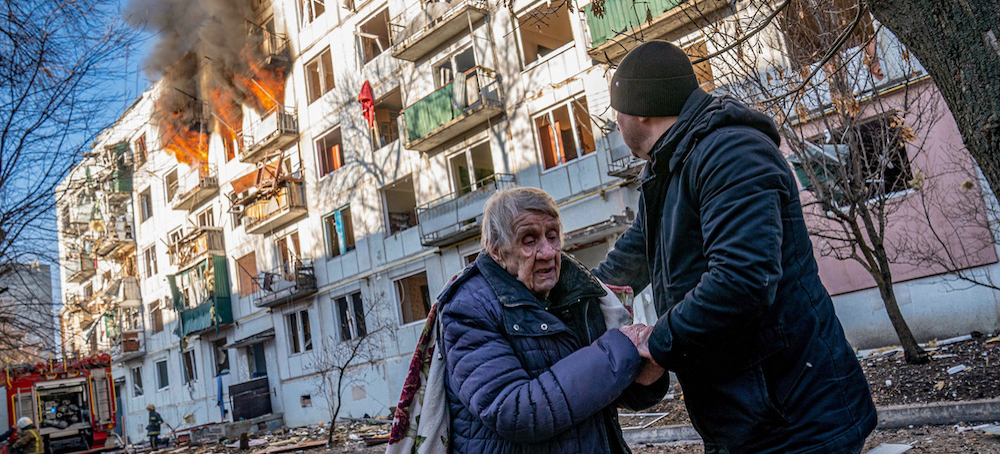 A woman gets assistance fleeing from a civilian apartment complex that was bombed in Chuhuiv, near Kharkiv, Ukraine. (photo: Alex Lourie/Redux) 