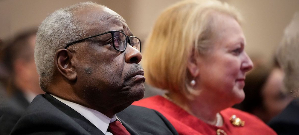 Associate Supreme Court Justice Clarence Thomas sits with his wife and conservative activist Ginni Thomas. (photo: Drew Angerer/Getty Images)
