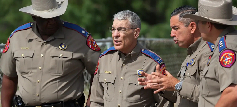 Steven C. McCraw, Director and Colonel of the Texas Department of Public Safety (2nd L), speaks with DPS State Troopers near Robb Elementary School on May 30, 2022, in Uvalde, Texas. (photo: Michael M. Santiago/Getty Images)