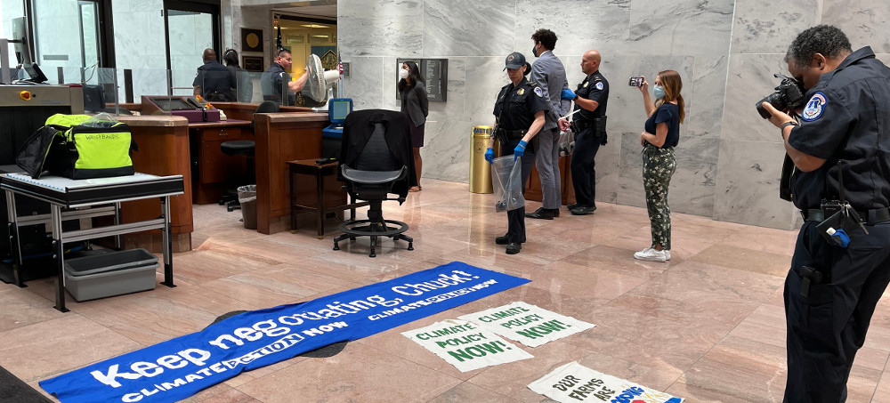 Police took photos of some of the banners and signs that the protesters had made, which advocated for Chuck Schumer to reopen climate-policy negotiations. (photo: Andrew Marantz/New Yorker)