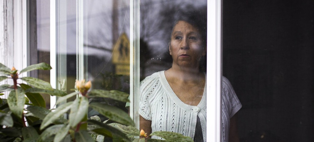 Laura Kealiher, mother of Sean Kealiher, a Portland antifacist activist killed in 2019, at the window of her home in Portland, Oregon, Jan. 30, 2021. (photo: Brooke Herbert/The Intercept)