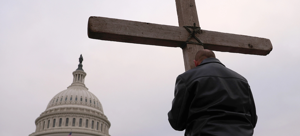 Supporters of former president Trump pray outside the U.S. Capitol in January. (photo: Win McNamee/Getty Images)