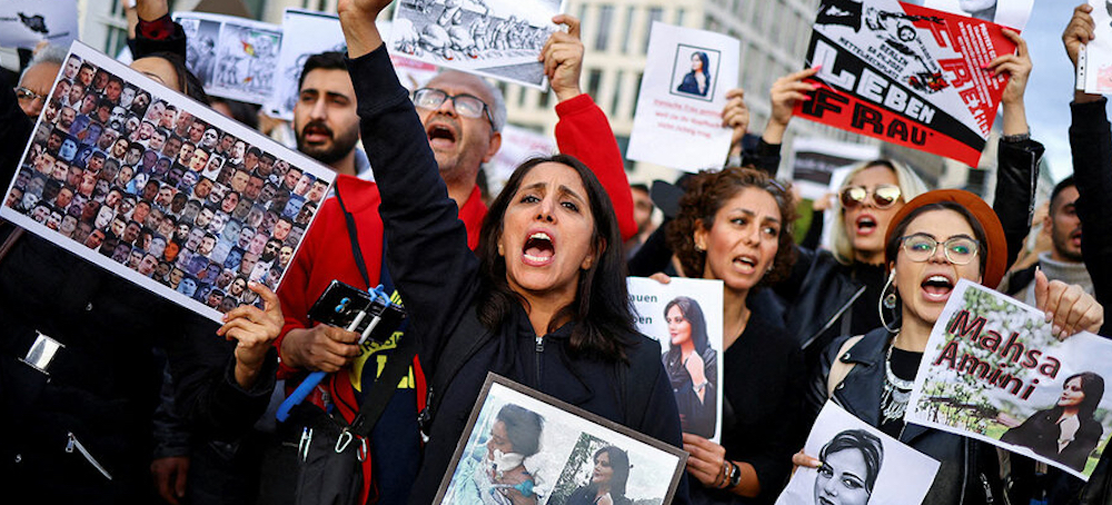 People take part in a protest following the death of Mahsa Amini. (photo: Christian Mang/Reuters)