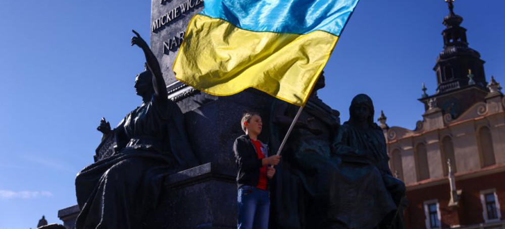 A boy holds a Ukrainian flag during a demonstration of solidarity with Ukraine at the Main Square, after latest Russian missiles targeted civilian infrastructure in several cities in Ukraine. Krakow, Poland, October 10, 2022. (photo: Beata Zawrzel-NurPhoto)