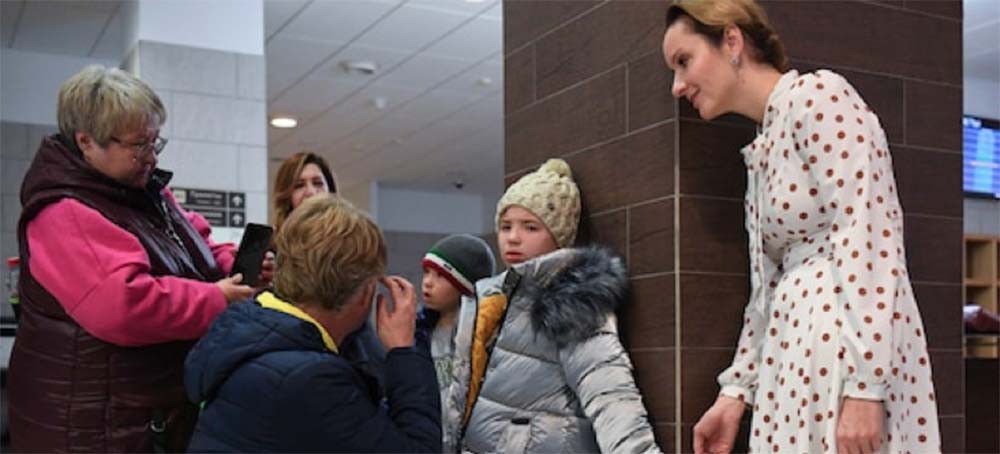 The Russian commissioner for children’s rights, Maria Lvova-Belova, right, takes part in an event to meet children who Russia says were orphans from the occupied Luhansk region of Ukraine and transfer them to foster parents at the Tolmachevo airport in Novosibirsk, Russia. (photo: Alexandr Kryazhev/Sputnik/AP)