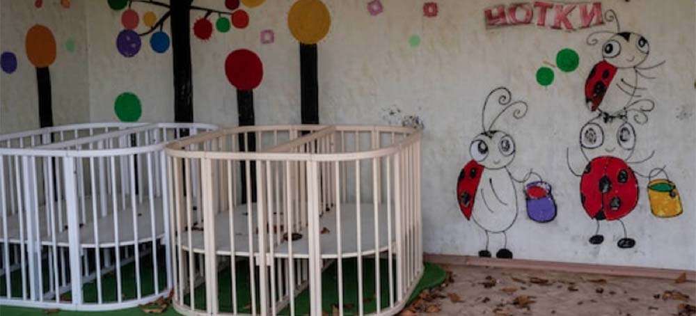 Empty cribs in the courtyard of Kherson regional children's home in southern Ukraine in November. (photo: Bernat Armangue/AP)