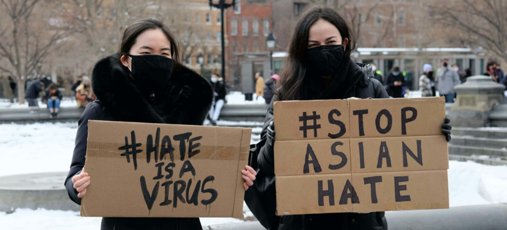 Protestors hold signs at the End The Violence Towards Asians rally in Washington Square Park, Feb. 20, in New York City. (photo: Dia Dipasupil/Getty)