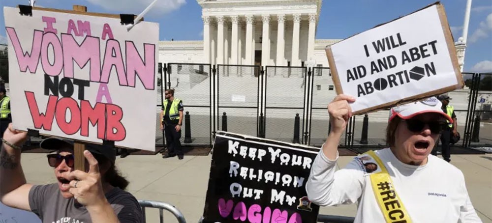 Abortion rights demonstrators protest outside the United States Supreme Court as the court rules in the Dobbs v Women’s Health Organization abortion case, overturning the landmark Roe v Wade abortion decision in Washington, U.S., June 24, 2022. (photo: Jim Bourg/Reuters)