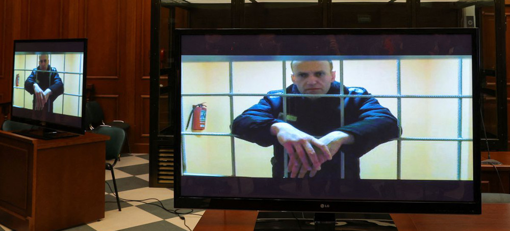 Russian opposition leader Alexei Navalny is seen on screens via a video link from the IK-2 corrective penal colony in Pokrov during a court hearing to consider an appeal against his prison sentence in Moscow, Russia, May 24, 2022. (photo: Evgenia Novozhenina/Reuters)