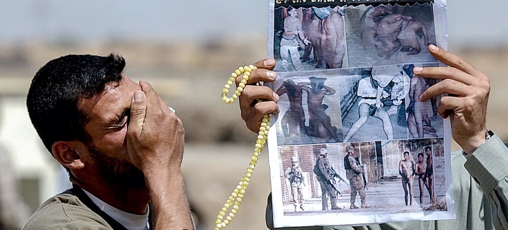 A relative of an Iraqi prisoner reacts to photos of prisoner abuse and torture by U.S. forces outside the prison in Baghdad, Iraq, on May 8, 2004. (photo: AFP)