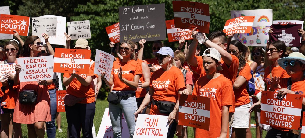 Demonstrators hold signs at a rally held by March Fourth near the U.S. Capitol on Wednesday, July 13, 2022, in Washington, that was calling for universal background checks for guns and an assault weapons ban in the wake of continued mass shootings. (photo: Mariam Zuhaib/AP)