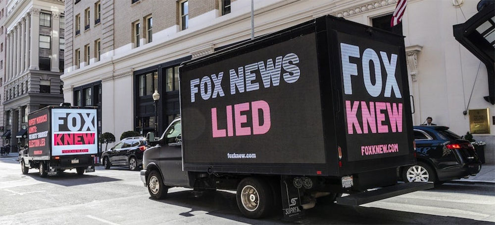 Truck billboards call out Fox News's election-denial scheme. (photo: Kimberley White/New Republic) 
