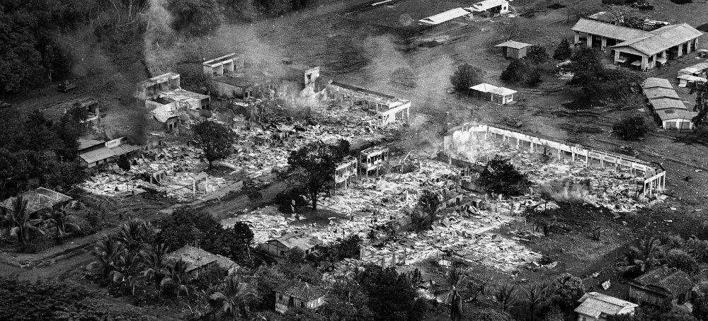 The town of Snuol, Cambodia, smolders in early May 1970, after the town was destroyed by U.S. firepower. (photo: Henri Huet/AP)