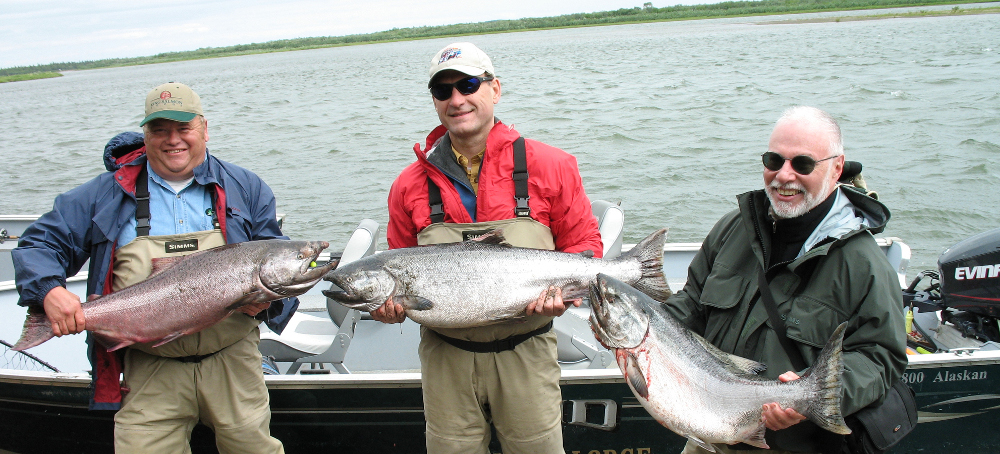 Supreme Court Justice Samuel Alito, center, and hedge fund billionaire Paul Singer, right, hold king salmon with another guest. (photo: ProPublica) 