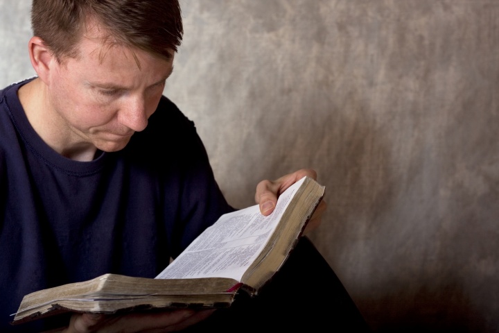 A man reading a Bible.