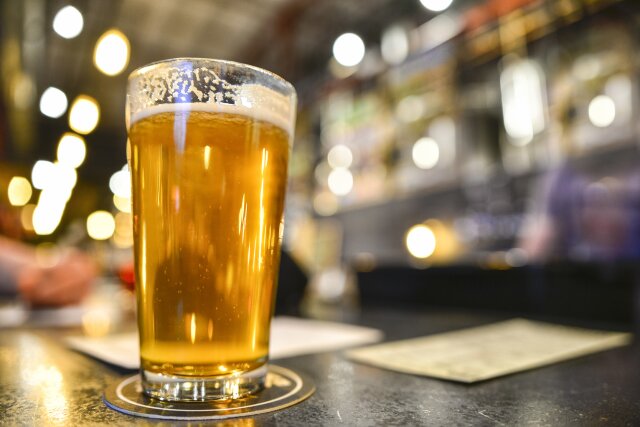 Pint of Craft Beer on Bar with Bokeh - stock photo
